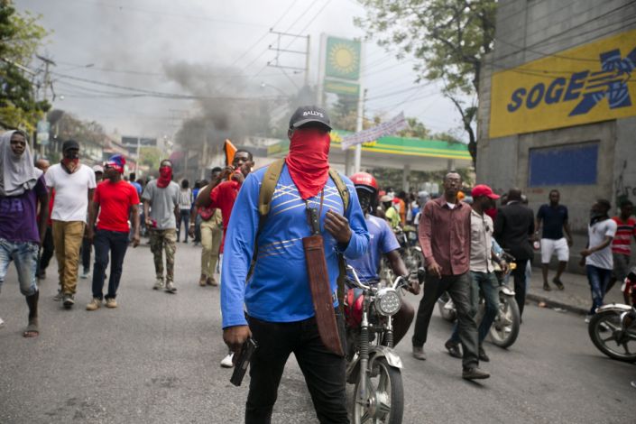 Armed off duty police officers protest over police pay and working conditions in Port au Prince