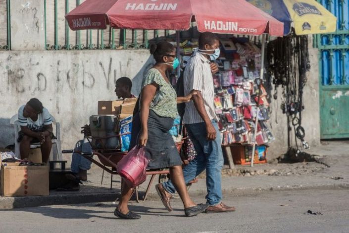 Two people in the Haitian capital Port au Prince wear face masks credit AFP Pierre Michel Jean